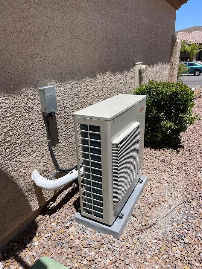 Residential air conditioning condenser unit in Two Rivers